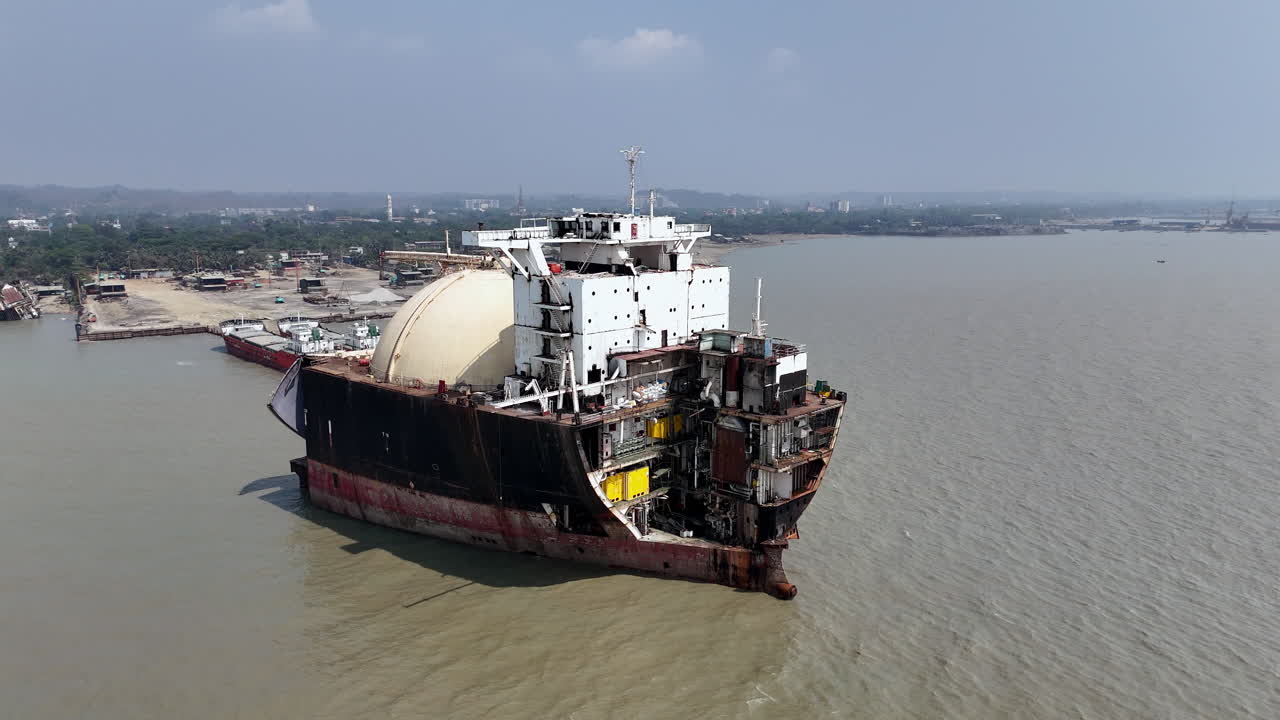 Revealing epic drone shot of a large ship abandoned in a ship graveyard in Bangladesh
