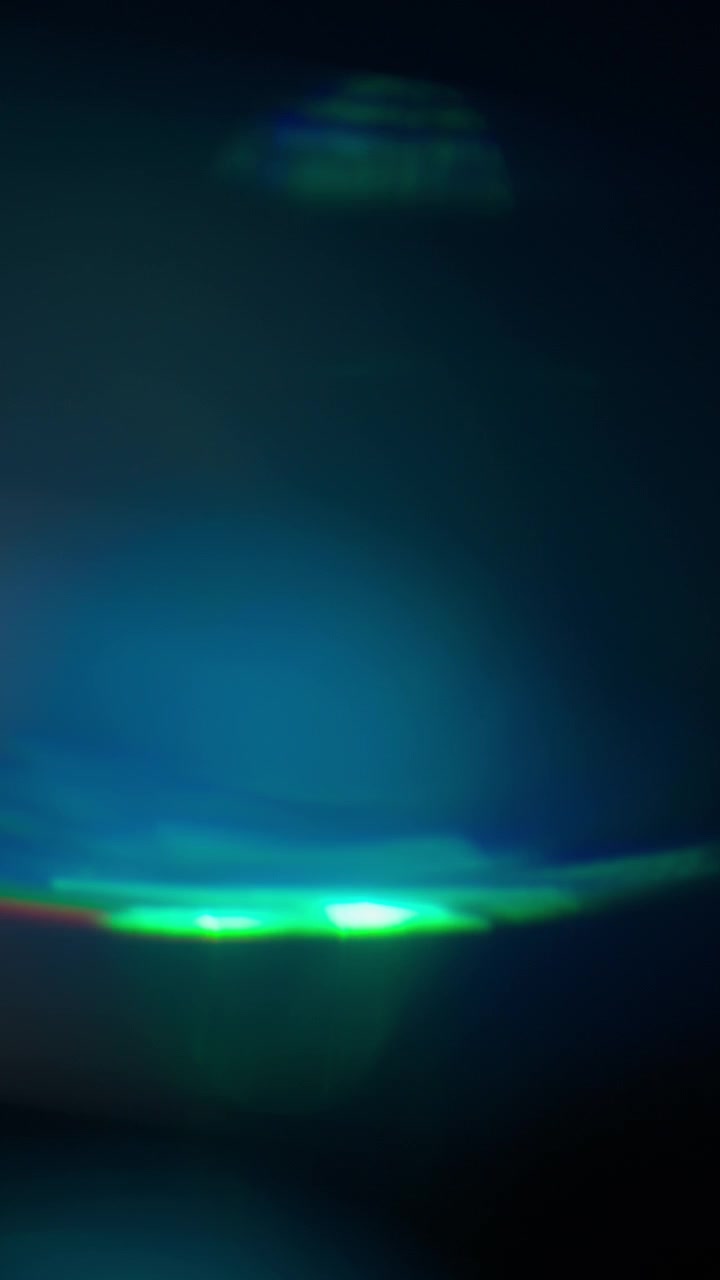 Prism overlays and light leaks in blue and green lighting
