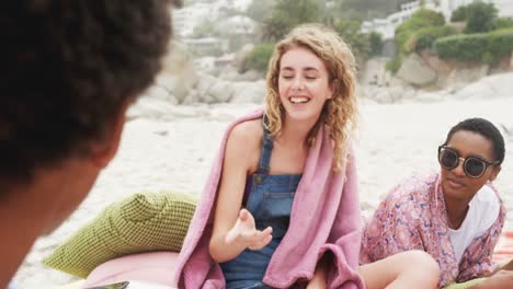 Front-view-of-Caucasian-woman-singing-song-with-friends-at-beach-4k