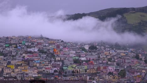 clouds drift over the rooftops and hillsides of quito ecuador 1