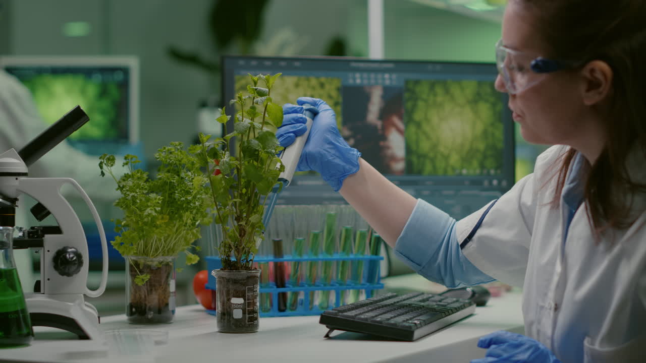 Biologist researcher using micropipette putting genetic solution in test tube