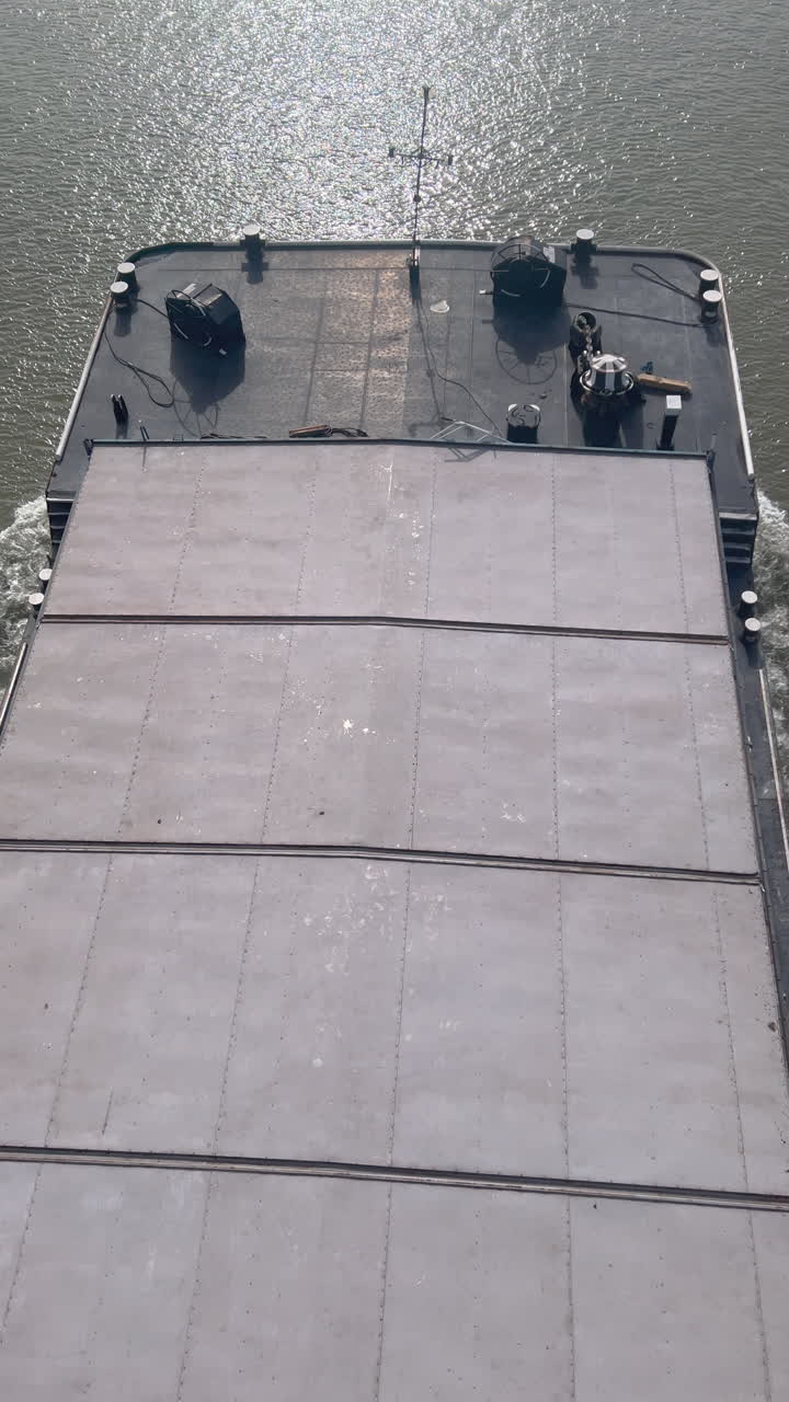 Freight ship on Danube river, high angle view vertical video