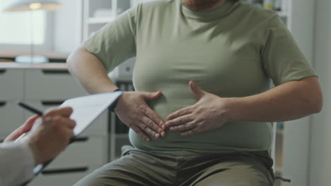 doctor examining a patient with abdominal pain
