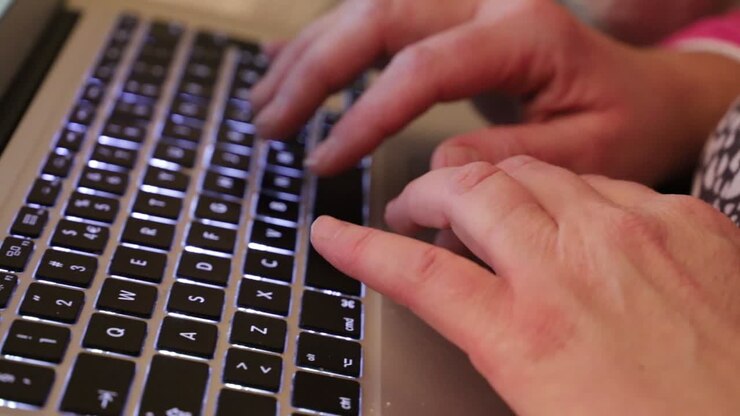 Mengetik surat di laptop