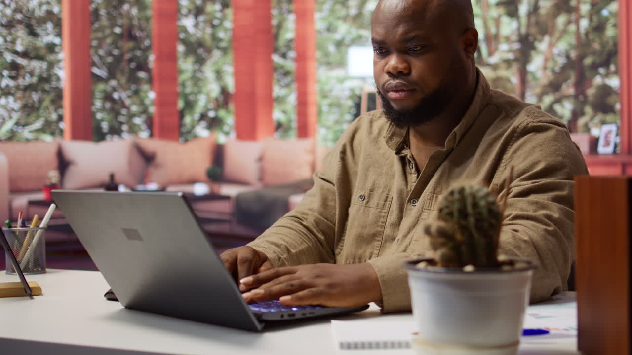 Self employed analyst working on financial audits and budget planning on laptop