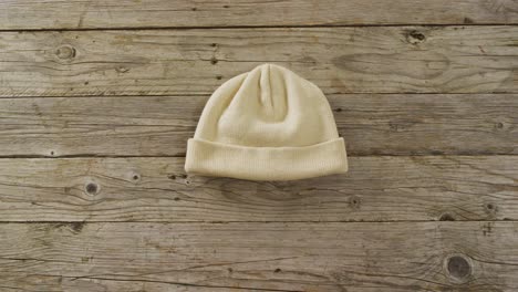 Video-of-close-up-of-hat-on-wooden-background