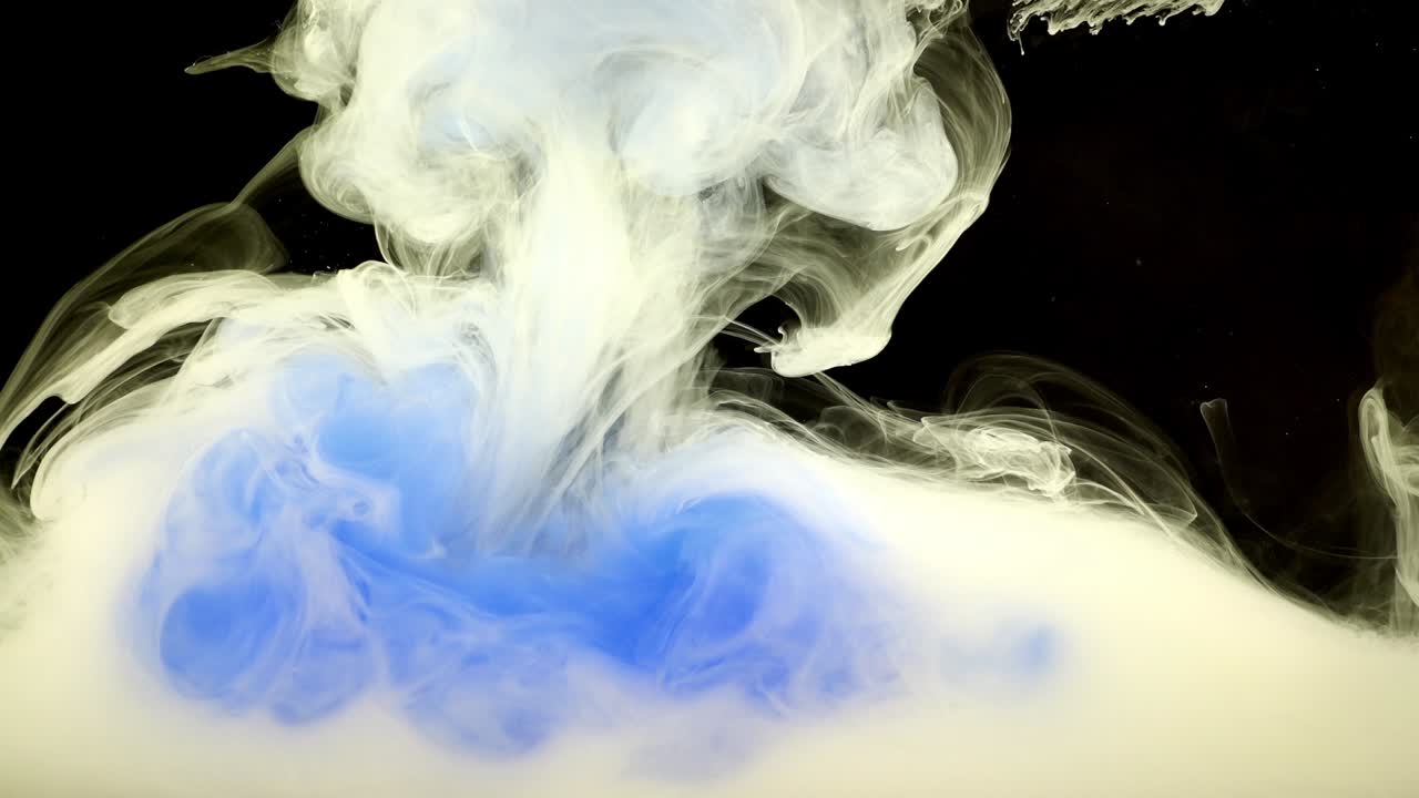 Abstract forms. Shooting on a black background. Mixing of paints