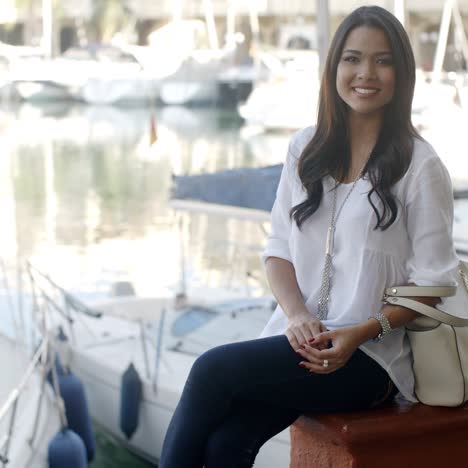 Woman-Relaxing-On-Bench-In-Yacht-Port