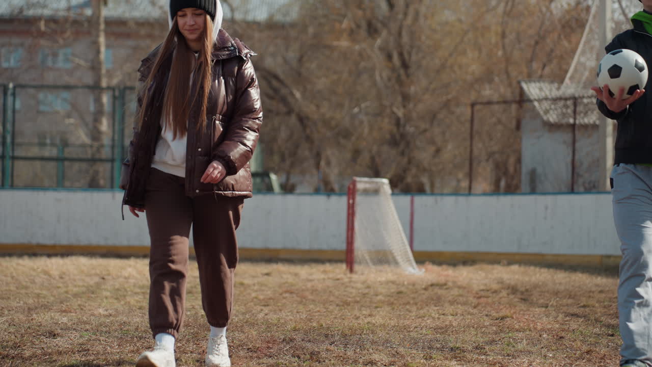 young players practicing, two young individuals engaging in casual soccer practice with enthusiasm, pair of youngsters sharing playful moments while passing soccer ball in relaxed setting