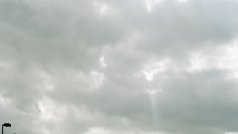 sun singing through the storm clouds in a parking lot