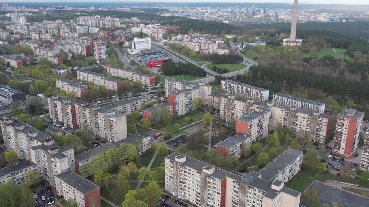 Drone advances over residential blocks with the Vilnius TV Tower visible on the right