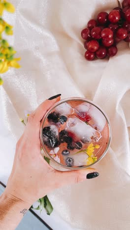 refreshing berry cocktail with ice and flowers