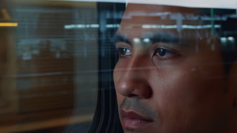 man looking out of a window with reflections