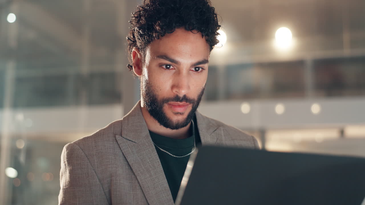 A man working on a laptop in an office