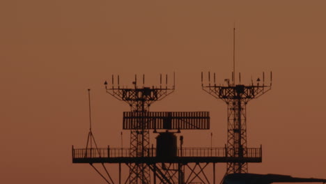 silhouetted antennas at sunset