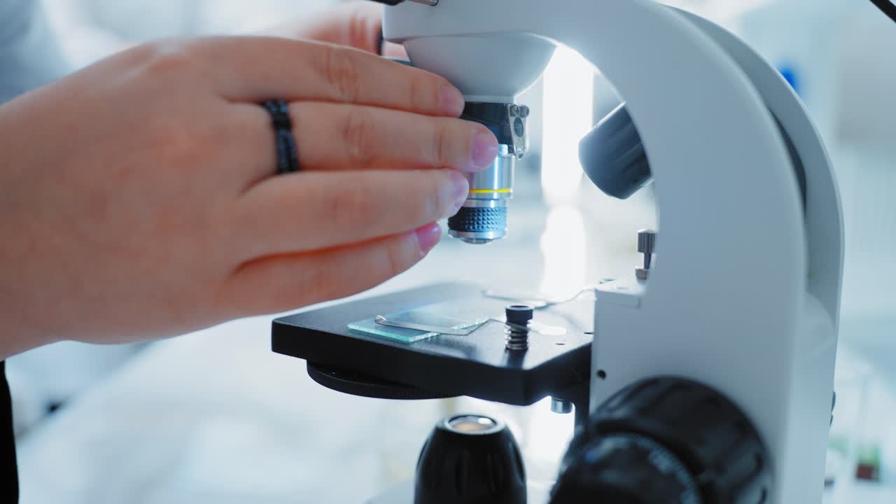Scientists Using Microscope in Lab