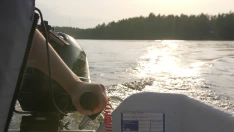 Riding-on-a-boat-with-engine,-hand-close-up-with-water-waves-and-sun