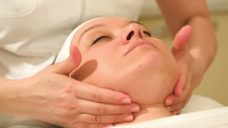 woman taking facial treatments at beauty spa