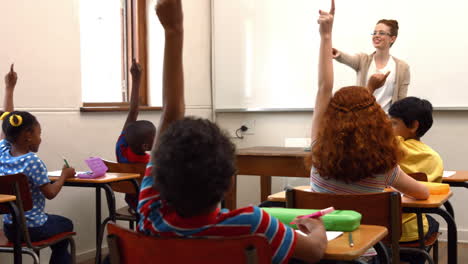 school children raising hands in class