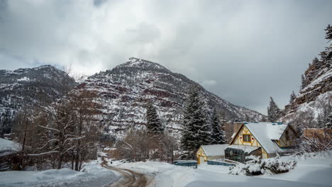 time lapse, idyllic winter scenery, mountain house, snow capped hills and countryside road, colorado usa