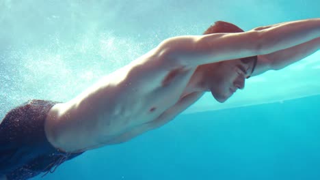 handsome man swimming underwater