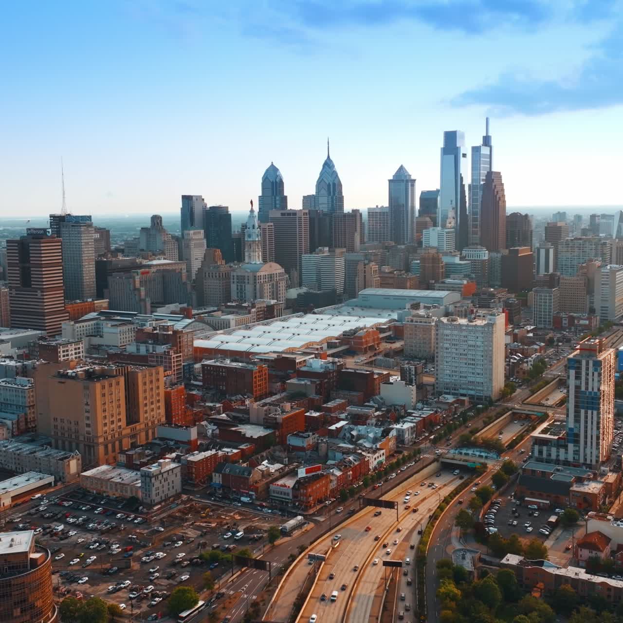 Distancing from the downtown of Philadelphia. Drone footage of the lively city at sunset