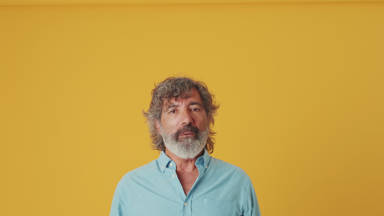 Mature Man Looks Up in Surprise and Smiles