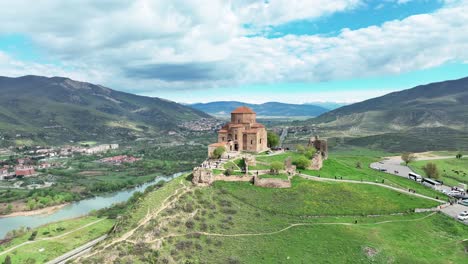 ancient jvari monastery on top of a mountain near mtskheta in eastern georgia - aerial orbit