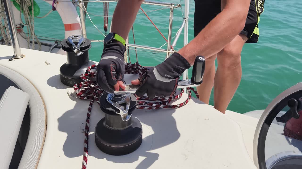 Sailor working on yacht winch