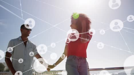 animation of network of connections over happy couple on the beach