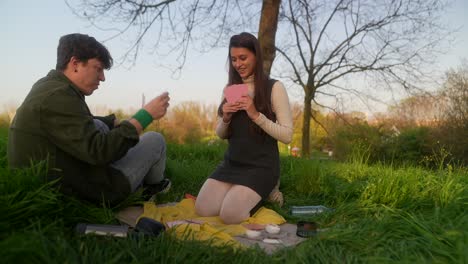 couple playing cards in a park