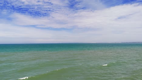 aerial view pan of the windy beach and the rocks in lam dong