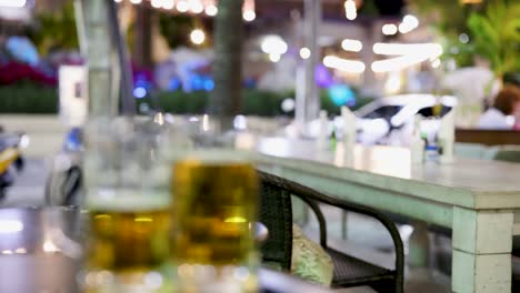 a bustling street bar in phuket, thailand, with blurred motion capturing vibrant nightlife and social interactions