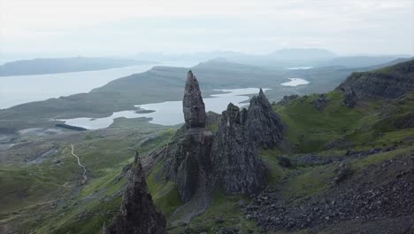 lateral movement drone shot above old man of storr rock formations in isle of skye scotland