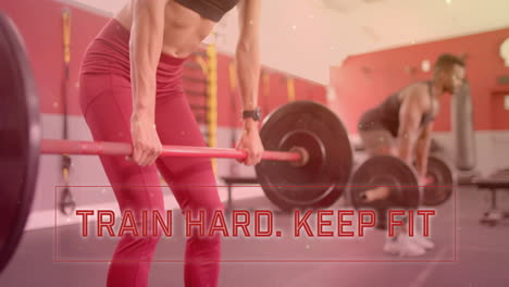 animation of train hard keep fit text over diverse man and woman exercising in gym, lifting weights