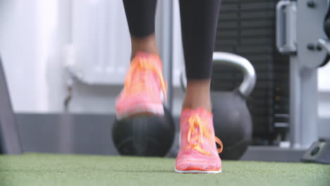 feet of a woman jumping rope at a gym