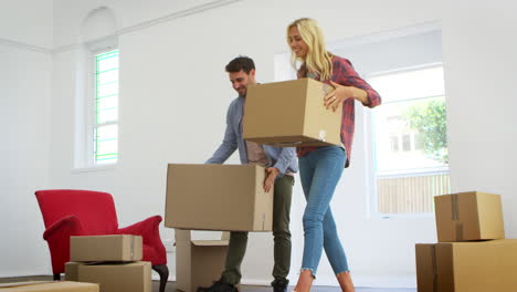 Couple-Carrying-Boxes-Into-New-Home-On-Moving-Day