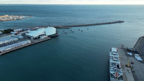 Aerial-flight-over-Port-area-of-Fremantle-with-docking-industrial-ship-and-marina-in-background---Perth-City,-Australia