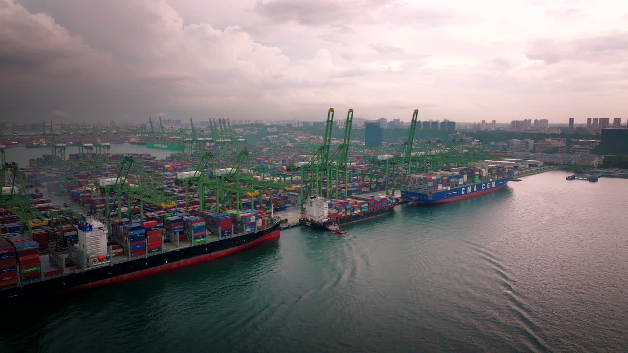 Aerial View of a Busy Container Port with Multiple Cargo Ships and Cranes