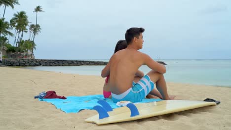 young couple sitting on beach 4k