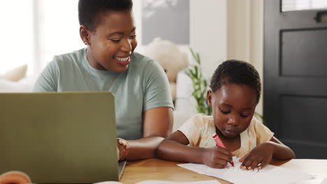 mother typing on laptop with kid