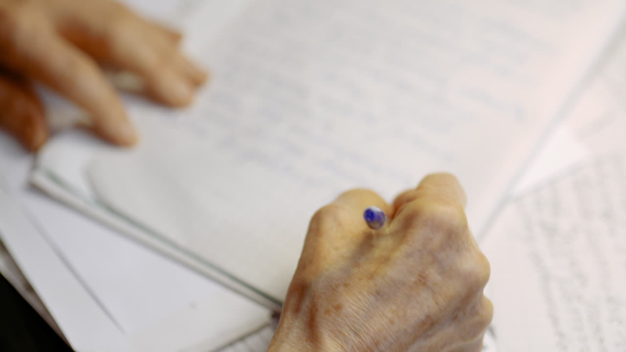 Senior Businessman Writing On Paper At Table In Office 11