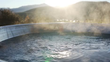 hot steaming hot tub bubbling during mountain sunset