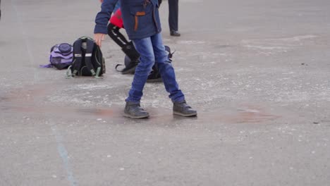 children playing outdoors on a school ground in winter