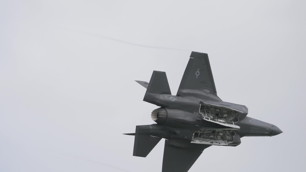 Fighter aircraft type F35 flies in slow motion with the bottom open. It's a close-up, taken at the air show called Airpower.