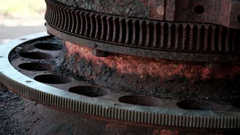 old rusted steel metal gears on a world war cannon in the south pacific