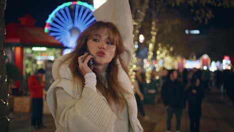 student calling luna park waving hand to friends closeup. woman talking phone