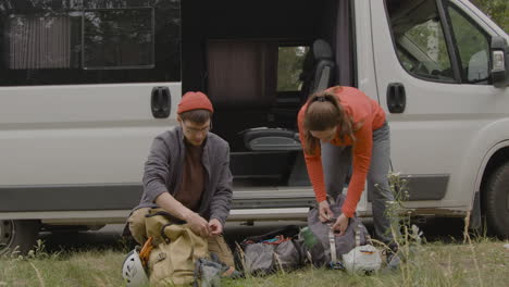 caucasian couple next to their van