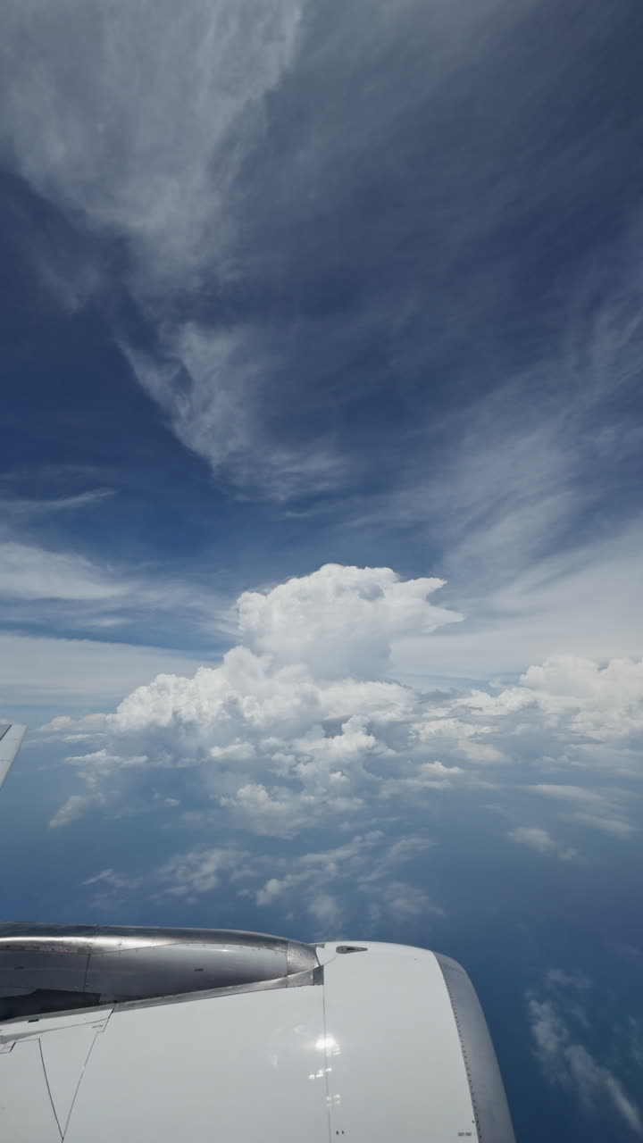 view from a plane window of the sky with the wing shot in vertical