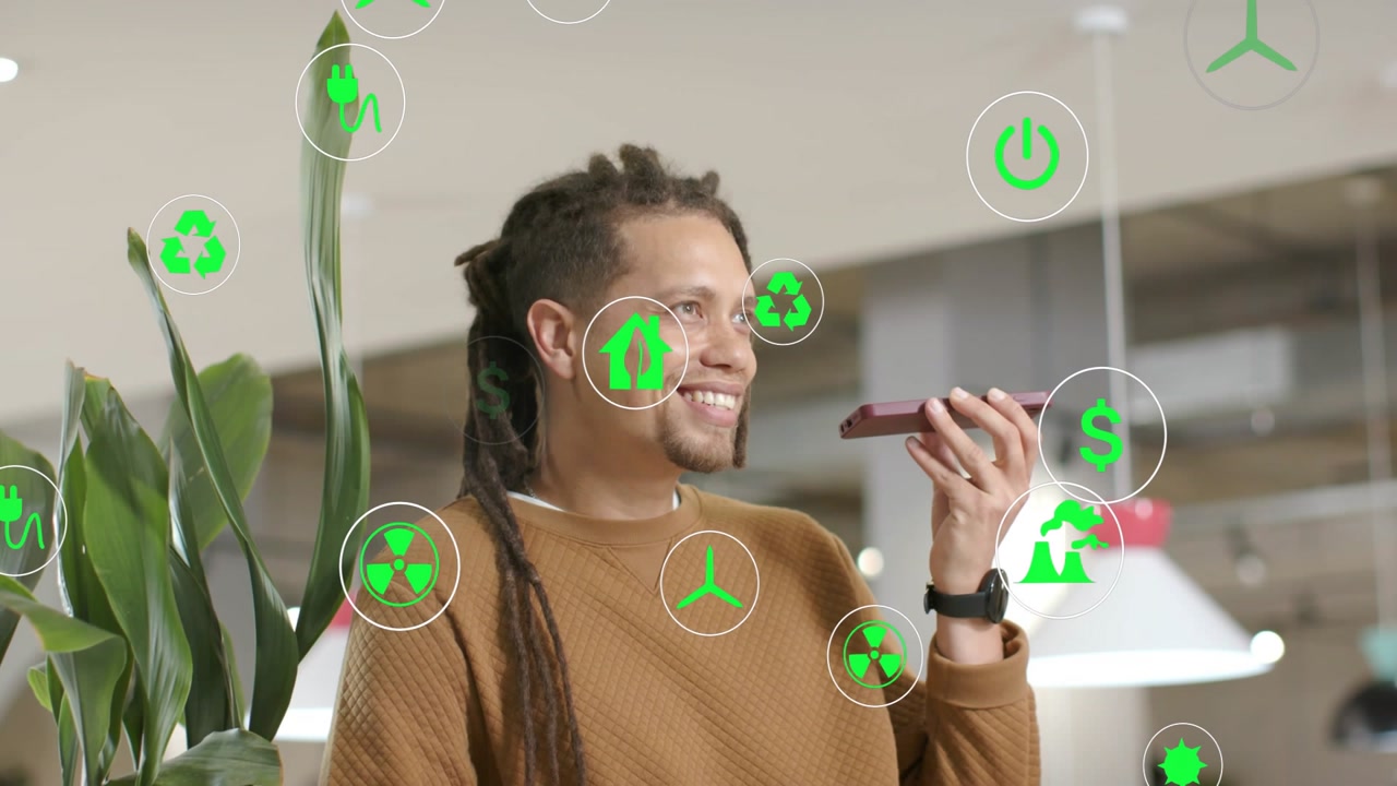 Man speaking into phone, pitching green finance while smiling, icons floating around face and torso